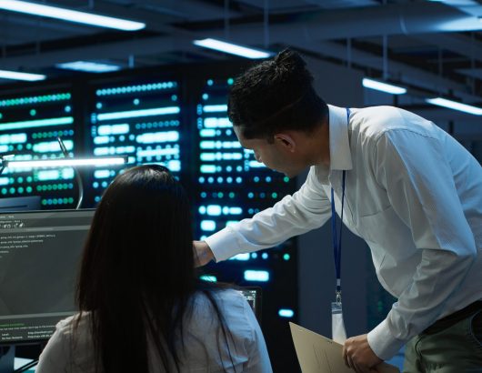 Computer scientists in data center managing and maintaining databases, ensuring data integrity and security. IT staff members updating server room systems using, camera A